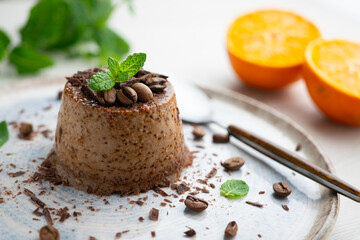 Homemade chocolate and coffee flan decorated with fresh mint. Traditional egg recipe.