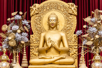 Fototapeta premium isolated holy statue of golden buddha at monastery at indoor