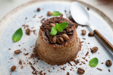 Homemade chocolate and coffee flan decorated with fresh mint. Traditional egg recipe.
