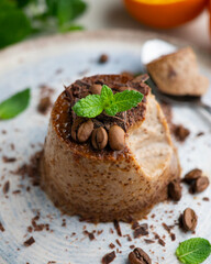 Homemade chocolate and coffee flan decorated with fresh mint. Traditional egg recipe.
