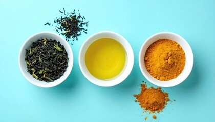 Three white bowls line a teal backdrop, holding dried tea, vibrant yellow oil, and a pile of turmeric powder, casting soft shadows