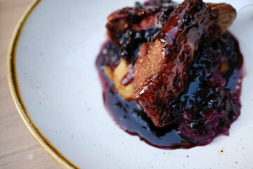 Roasted duck leg with berry sauce and red cabbage, fine dining in Timisoara, Romania