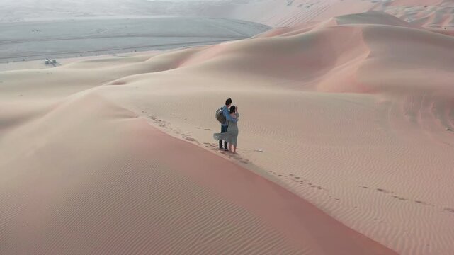 Romantic Couple in an Empty Desert at Sunset