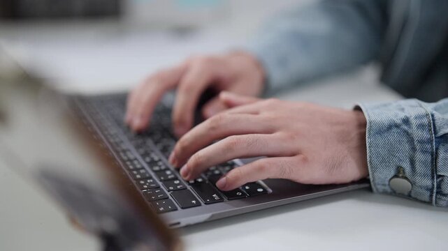 Close-up of Hands Typing Code on Laptop Keyboard, Highlighting Remote Work and Software Development