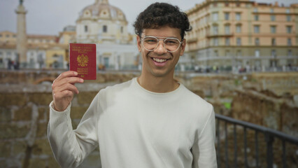 Man wearing white sweater holding passport and pointing finger at it at roman building; travel adventure.