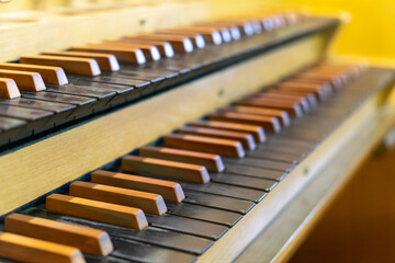 Antique organ keyboard and controls in a Lutheran church.