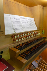 Antique organ keyboard and controls in a Lutheran church.