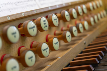Antique organ keyboard and controls in a Lutheran church.