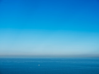 Obraz premium lonely sailing boat in channel near dover on early foggy morning