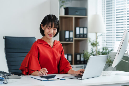 Businesswomen working with tablet and using a calculator to calculate the tax of static in office. Finance accounting concept. - Powered by Adobe