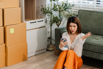 Depressed woman sitting next to the sofa sad, feeling tired, lonely and unhappy. house debt...