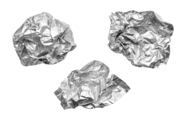 Three crumpled pieces of shiny, metallic foil against a black background