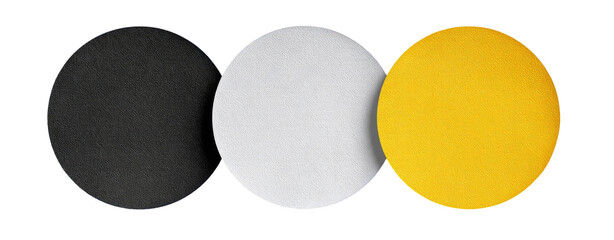 Three circular shapes in black, white, and yellow