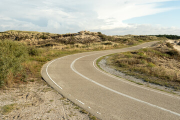 Winding bicycle path through dutch dunes in wassenaar, netherlands