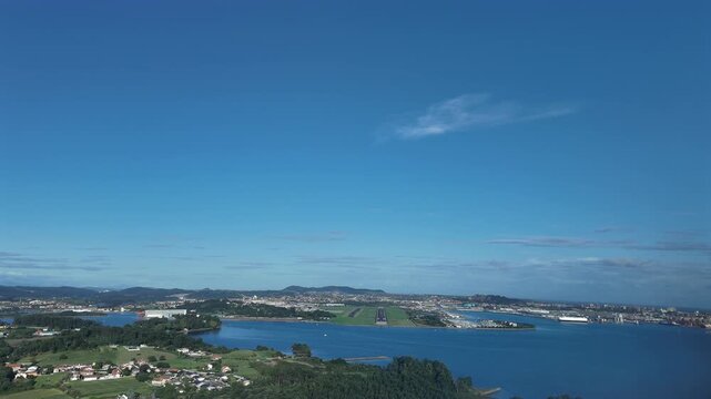 an immersive pilot&rsquo;s eye view FPV from the cockpit of a jet approaching to Santander airport runway RWY 29, overflying the bay, with a view of the city on the right, in a splendid sunny morning