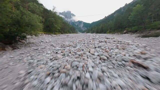 FPV drone flight over dry riverbed in Ges&auml;use National Park Austria
