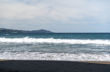 The cold Atlantic Ocean, the white foam of the waves and the golden sand of Zumaia beach