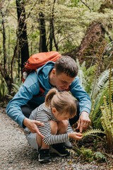 A father and daughter explore a nature trail on a forest path, adventure. Travel. New Zealand
