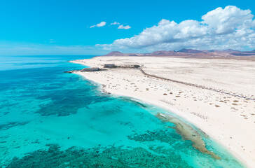 High quality aerial panoramic image of the beautiful Flag Beach, Grandes Playas with Lobos island in the background near Corralejo in Fuerteventura Spain
