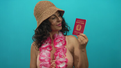 Woman wearing bikini and hawaiian lei holds italian passport against green background, showcasing...