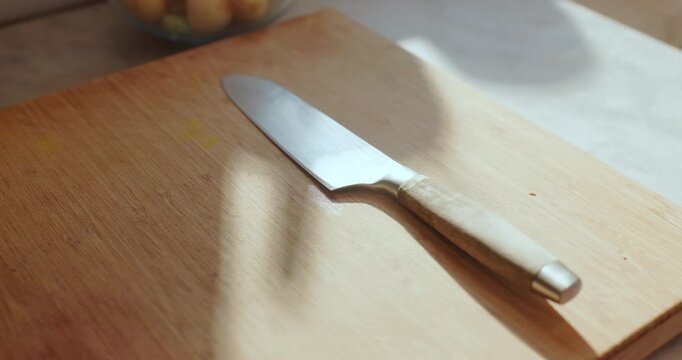 Chopping board, cooking and knife on counter in kitchen of home for meal preparation or utensil. Background, space and wallpaper with meat cleaver on butcher block for health, diet or nutrition