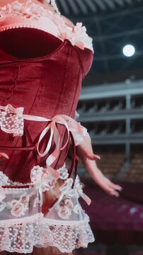 A seductive woman in red lingerie and lace poses in a dark and alluring setting. Perfect for themes of beauty, fashion, confidence, and sensuality.