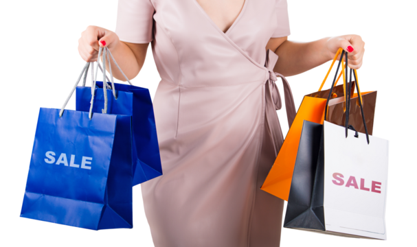 Closeup female holding multiple shopping bags isolated on transparent background. Successful retail excursion during sale season. Diverse haul of new purchases from a bargain filled trip