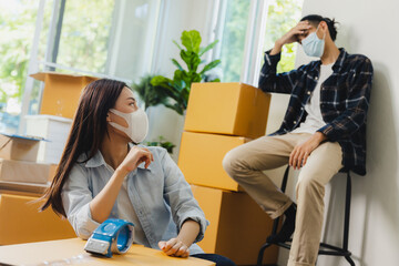 Asian couple is stressed out packing up to move to a new house.