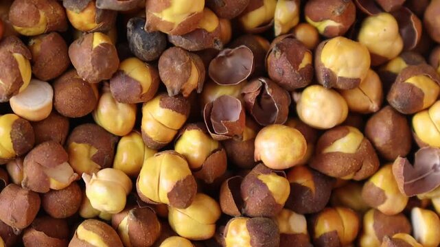 Roasted chickpeas rustic top down footage showing cracked shells and colorful natural kernels for background use