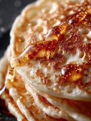 Delicious homemade pancakes topped with syrup, showcasing a perfect breakfast delight