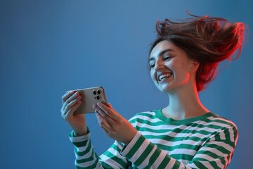 Happy woman with beautiful long hair using smartphone in neon lights against blue background, low...