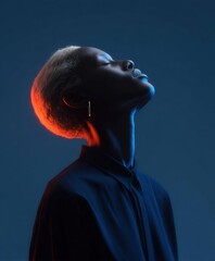 Elegant portrait of a model with striking lighting and serene expression captured in a studio