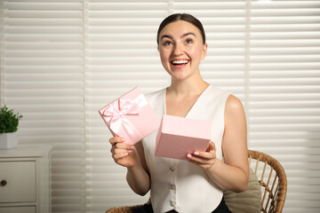 Dreams come true. Happy woman with gift at home
