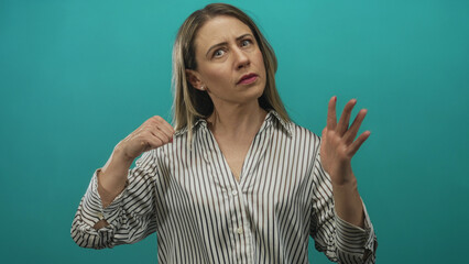 Middle aged woman wearing striped shirt makes denial gesture in studio; rejection defiance frustration anger.