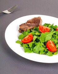 Grilled steak with arugula salad