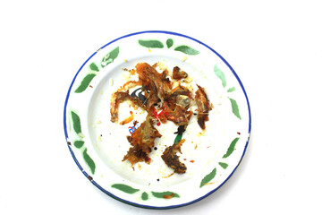 fish bone remains on a plate isolated on a white background