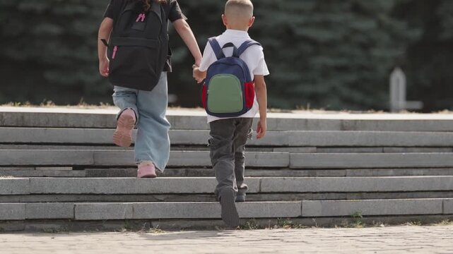 Two children walking upstairs hand in hand on a school morning. A slow-motion moment symbolizing growth, learning, and shared journey into the future.