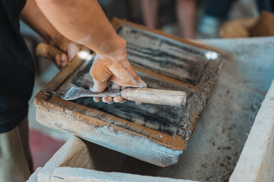 Manual clay tile making with worker shaping, drying and organizing terracotta in traditional workshop showing heritage craft and raw material process