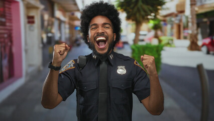 Joyful policeman celebrates on a vibrant city street outdoor, showcasing happiness and success.