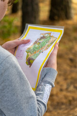 Athlete holding a map during orienteering competitions.
