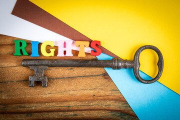 Creative symbolic image showing the word rights in colorful wooden letters beside an old vintage...