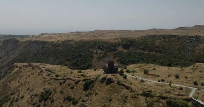 Aerial view of the ancient Amberd Fortress sitting atop rolling hills and arid landscape, a testament to time, Mount Aragats, Shirak Province, Armenia.