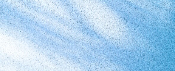 Shadows from a tree branch on a blue textured wall. An abstract background with natural light and a calming, serene atmosphere. © โยธิน ทุมจีน