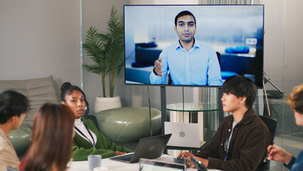 Diverse office teamwork startup meeting with people collaborating in modern workspace and video conference technology for creative project discussion