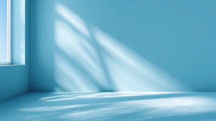 Bluetoned room with window light and shadows falling on the wall and floor