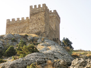 Detailed view of the stone tower and defensive wall of the Genoese fortress. The medieval...