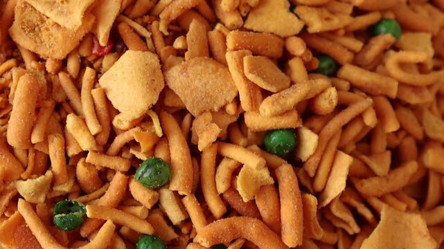 Chevdo mixture macro close up 4k video with fried noodles and green peas