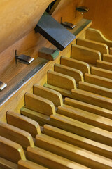 Close up of the ancient wooden pedals on the organ in a historic Lutheran church