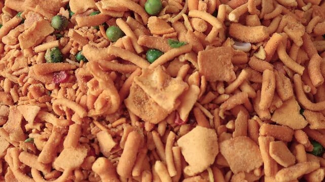 Namkeen chevdo pile close up cinematic video showing crispy fried snacks with vibrant textures