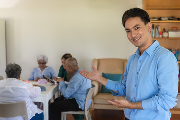 Fototapeta premium Smiling Asian man feeling happy to visit grandparents in senior home care